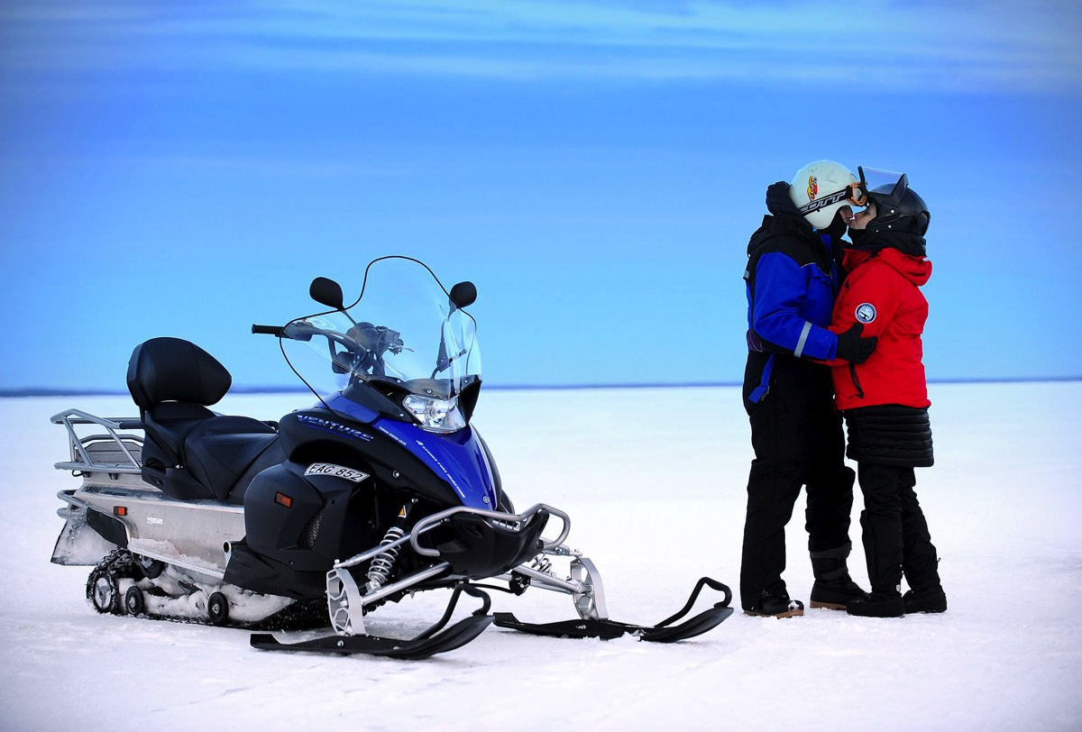 Snowmobiling couple Pine Bay Lodge